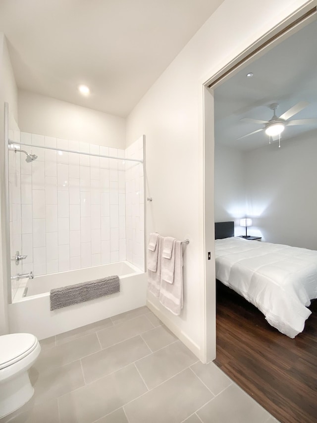 bathroom featuring ceiling fan, toilet, tub / shower combination, and tile patterned flooring