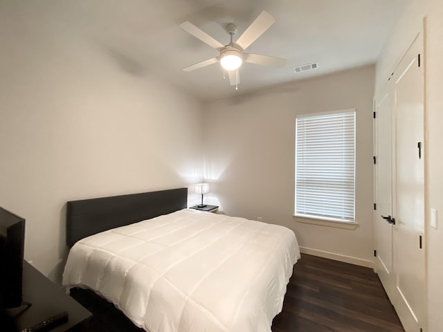 bedroom with ceiling fan and dark hardwood / wood-style flooring