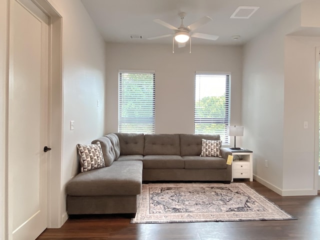 living room with ceiling fan and dark hardwood / wood-style flooring