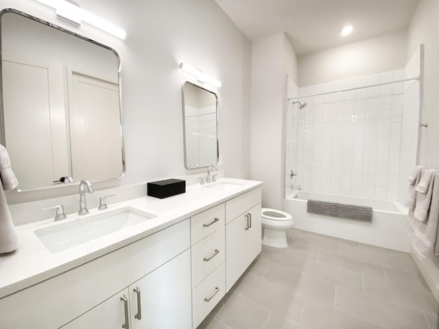 full bathroom with vanity, toilet, tiled shower / bath combo, and tile patterned flooring