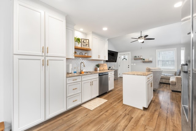 kitchen featuring white cabinetry, dishwasher, sink, and a kitchen island