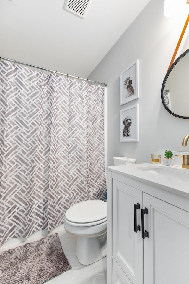 bathroom with vanity, tile patterned floors, and toilet