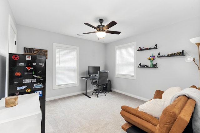 carpeted office featuring ceiling fan