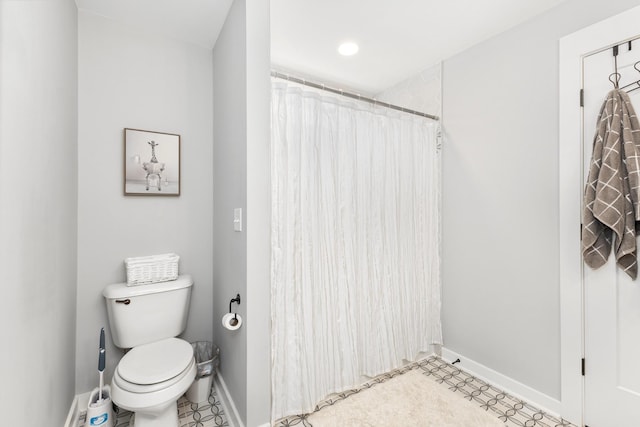 bathroom featuring a shower with shower curtain and toilet