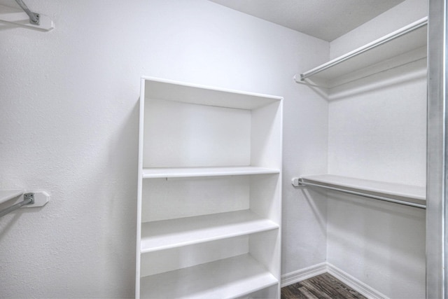 walk in closet featuring hardwood / wood-style flooring