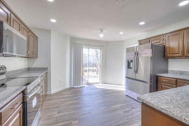 kitchen with stainless steel appliances and light hardwood / wood-style floors