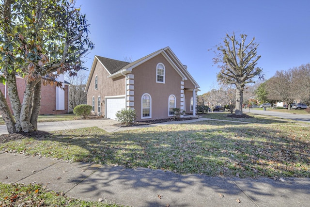 view of property exterior with a garage and a yard