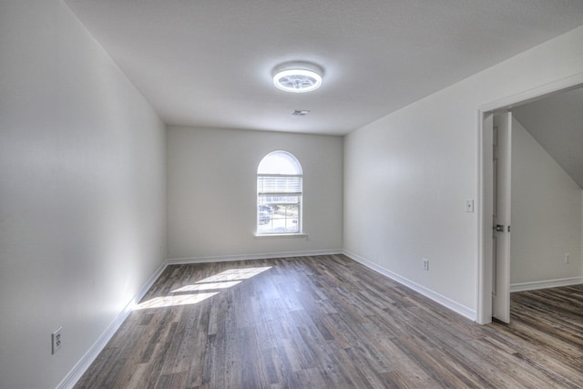 spare room with wood-type flooring