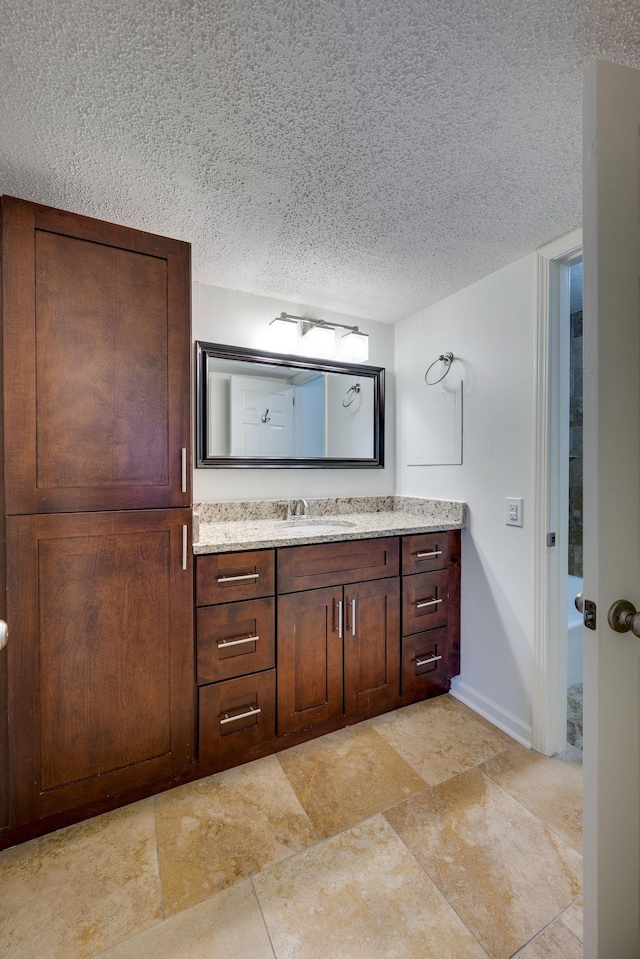 bathroom with vanity and a textured ceiling