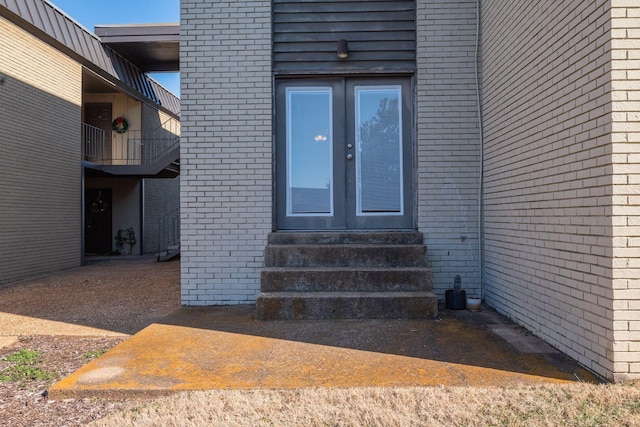 view of exterior entry featuring french doors