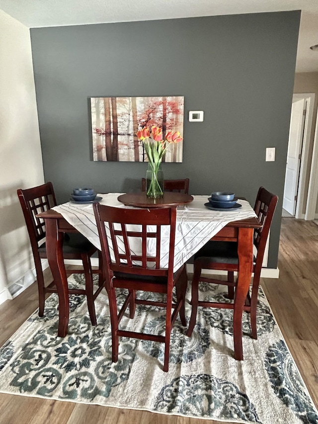 dining space featuring hardwood / wood-style flooring