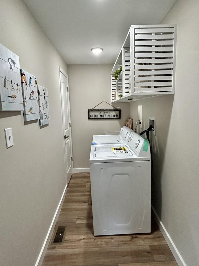 laundry room featuring dark hardwood / wood-style floors and washer and dryer