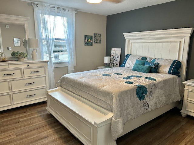 bedroom with dark hardwood / wood-style floors