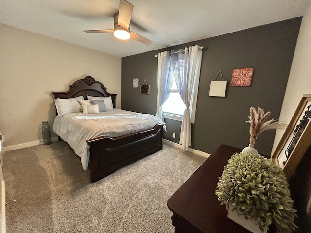 bedroom featuring ceiling fan and dark carpet