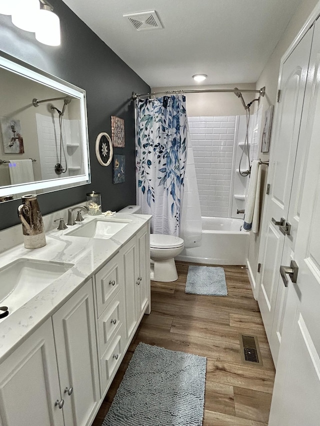 full bathroom with vanity, wood-type flooring, shower / bath combo, and toilet