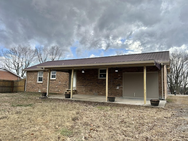 rear view of property featuring a patio area and a lawn