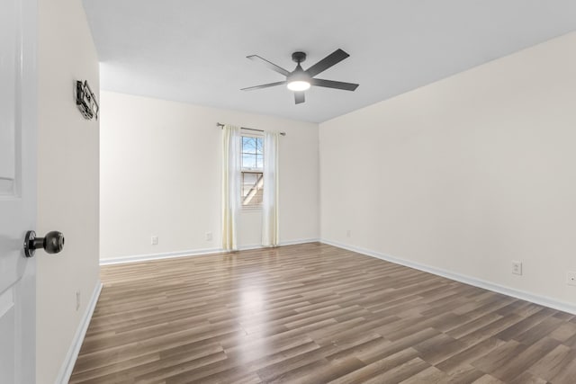 empty room featuring hardwood / wood-style flooring and ceiling fan