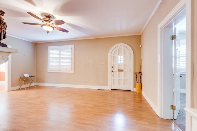 unfurnished living room featuring crown molding, ceiling fan, and light wood-type flooring