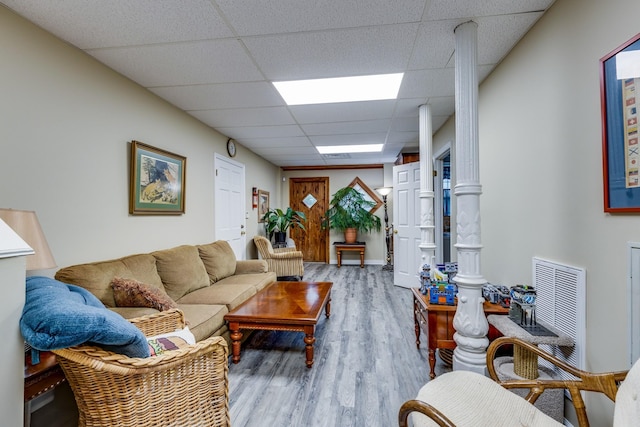 living room with a paneled ceiling and hardwood / wood-style floors