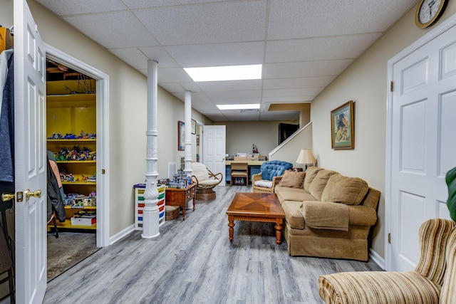 living room with hardwood / wood-style floors and a drop ceiling