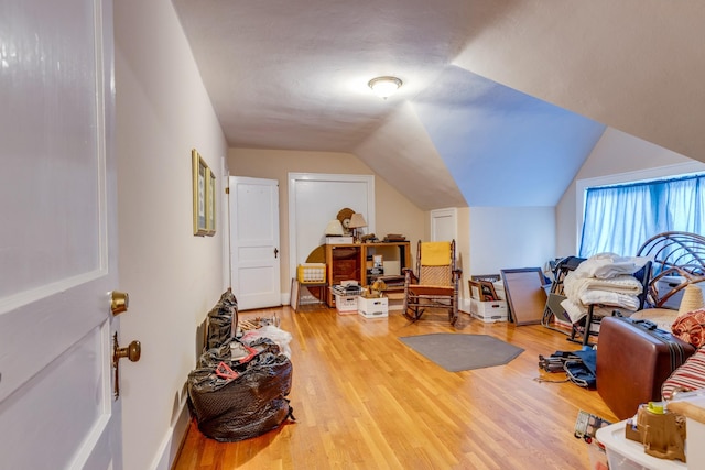 interior space with lofted ceiling and light hardwood / wood-style floors