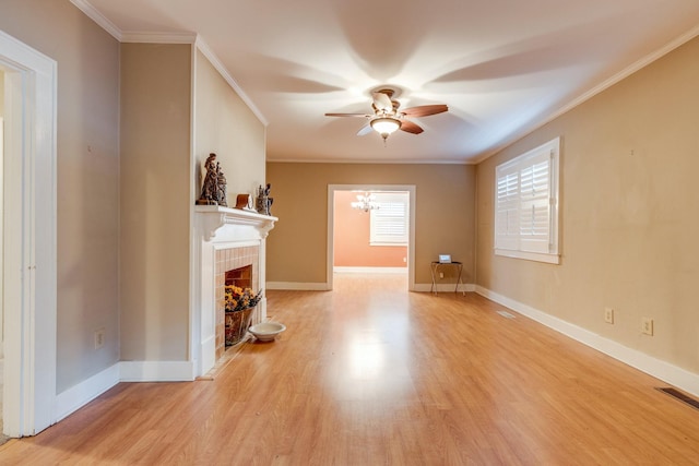 unfurnished living room featuring crown molding, ceiling fan with notable chandelier, light hardwood / wood-style floors, and a tile fireplace