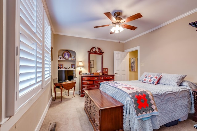 carpeted bedroom featuring ornamental molding and ceiling fan