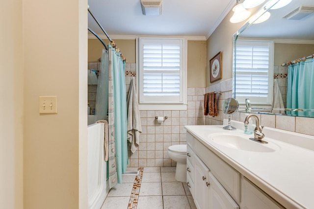 bathroom featuring vanity, a healthy amount of sunlight, tile walls, and toilet