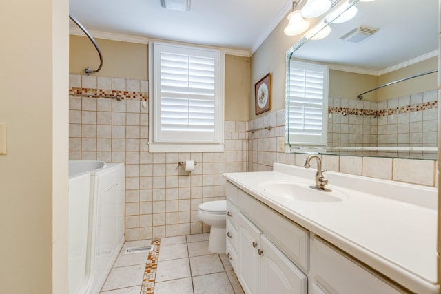 bathroom with tile walls, vanity, ornamental molding, toilet, and tile patterned floors