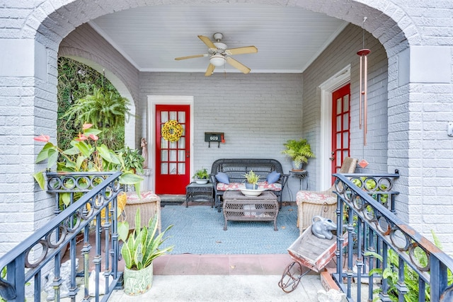 view of exterior entry with ceiling fan and covered porch