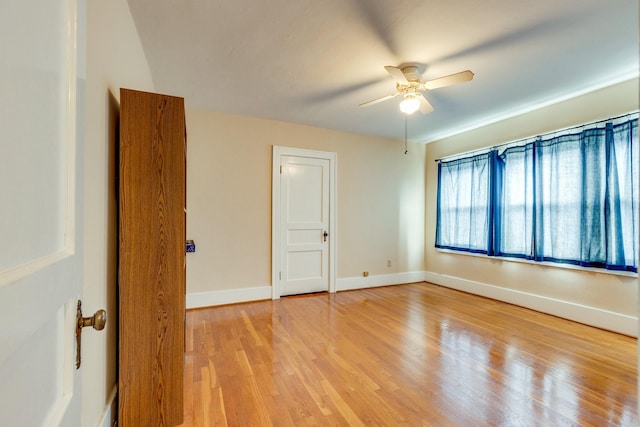 spare room featuring ceiling fan and light hardwood / wood-style floors