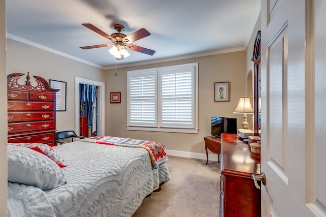 bedroom featuring ceiling fan, ornamental molding, a closet, and light carpet