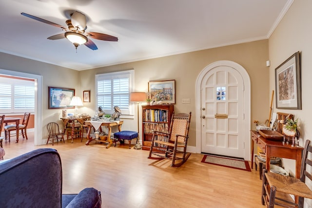 entryway with ornamental molding, light hardwood / wood-style floors, and ceiling fan