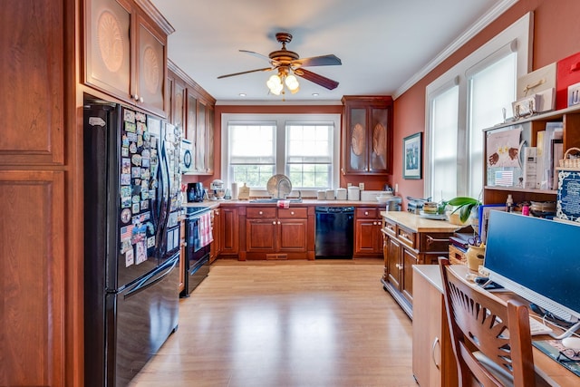 kitchen with sink, ceiling fan, ornamental molding, black appliances, and light hardwood / wood-style floors