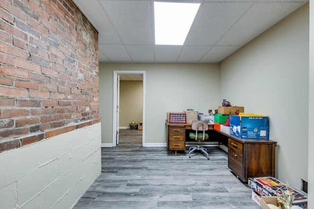 office area featuring hardwood / wood-style flooring and a paneled ceiling