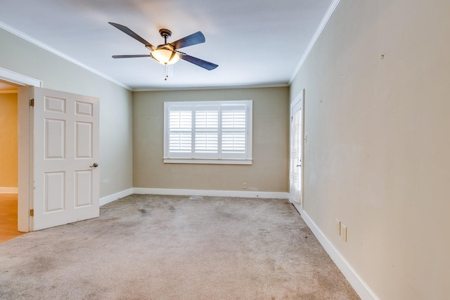 carpeted empty room featuring crown molding and ceiling fan