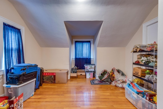 additional living space featuring lofted ceiling and light wood-type flooring