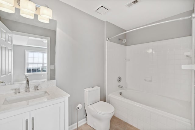 full bathroom with vanity, toilet, and tiled shower / bath combo