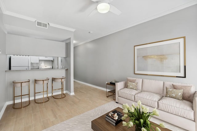 living room with crown molding, ceiling fan, and light hardwood / wood-style flooring