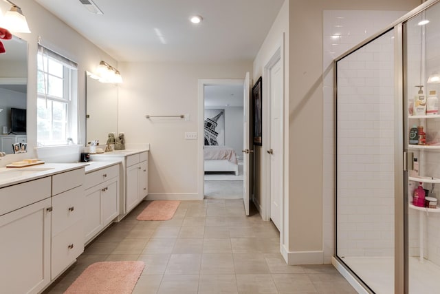 bathroom featuring vanity, a shower with shower door, and tile patterned floors