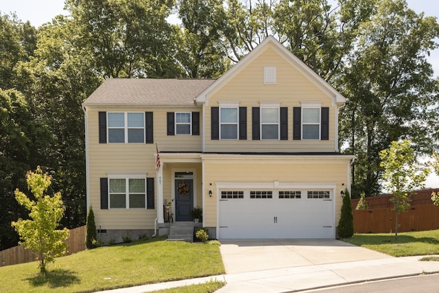 view of front of property featuring a garage and a front yard