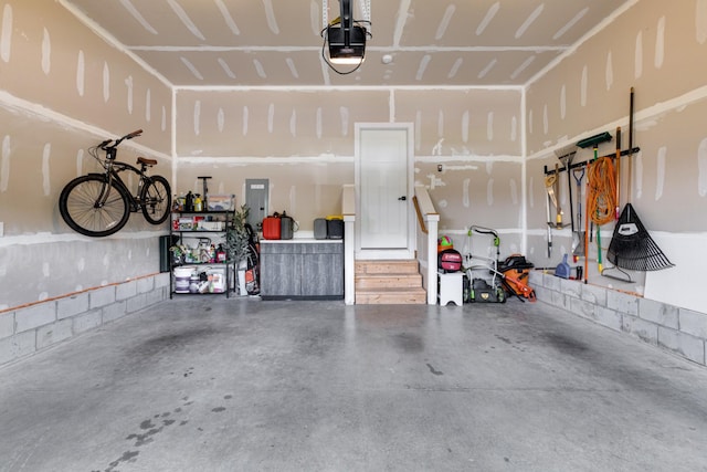 garage with a garage door opener and electric panel