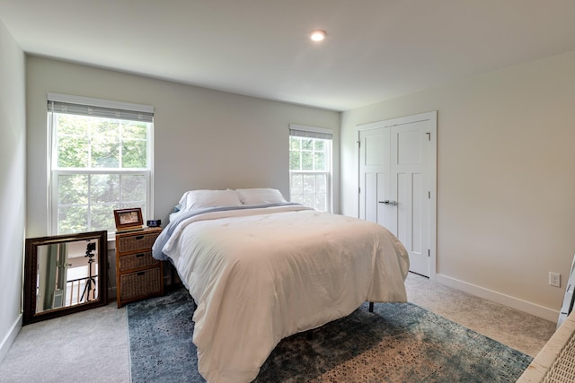 carpeted bedroom with a closet