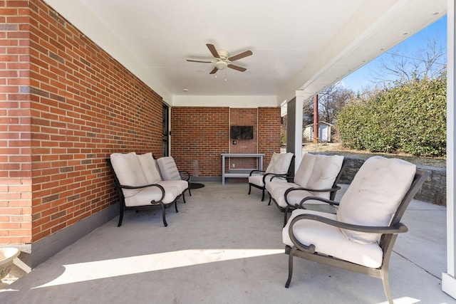 view of patio / terrace featuring ceiling fan and a fireplace