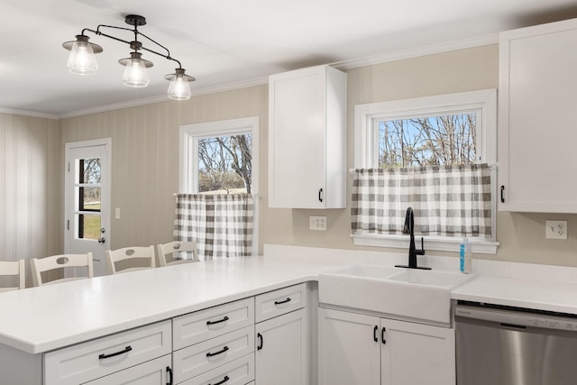 kitchen featuring white cabinetry, pendant lighting, and stainless steel dishwasher