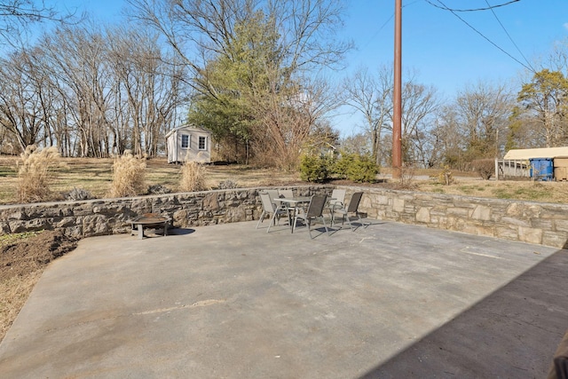 view of patio / terrace with an outdoor structure and a fire pit