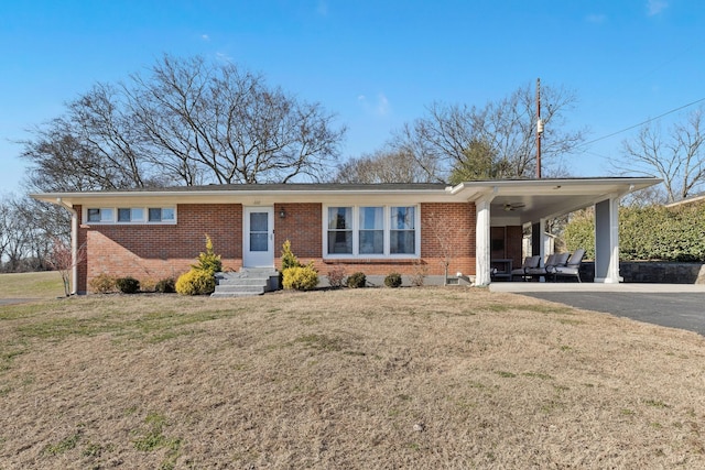 ranch-style house with a carport and a front yard