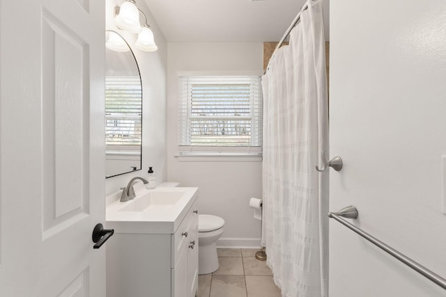 bathroom with vanity, tile patterned flooring, and toilet