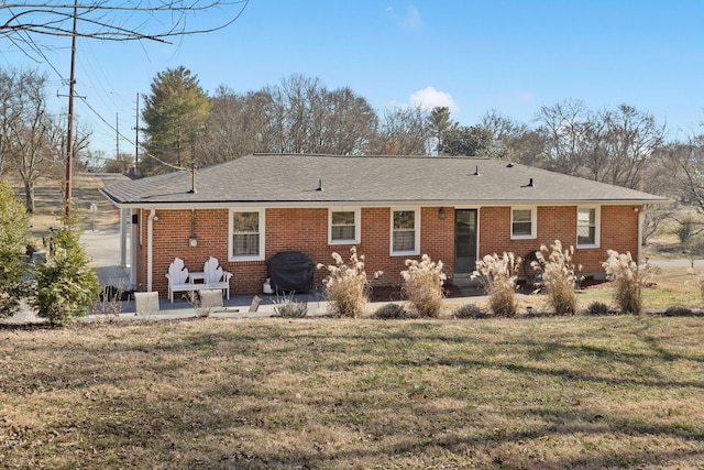 back of property featuring a patio and a lawn