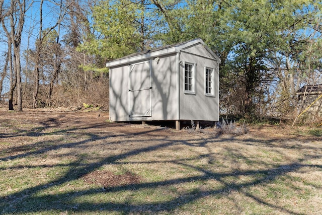 view of outbuilding with a yard